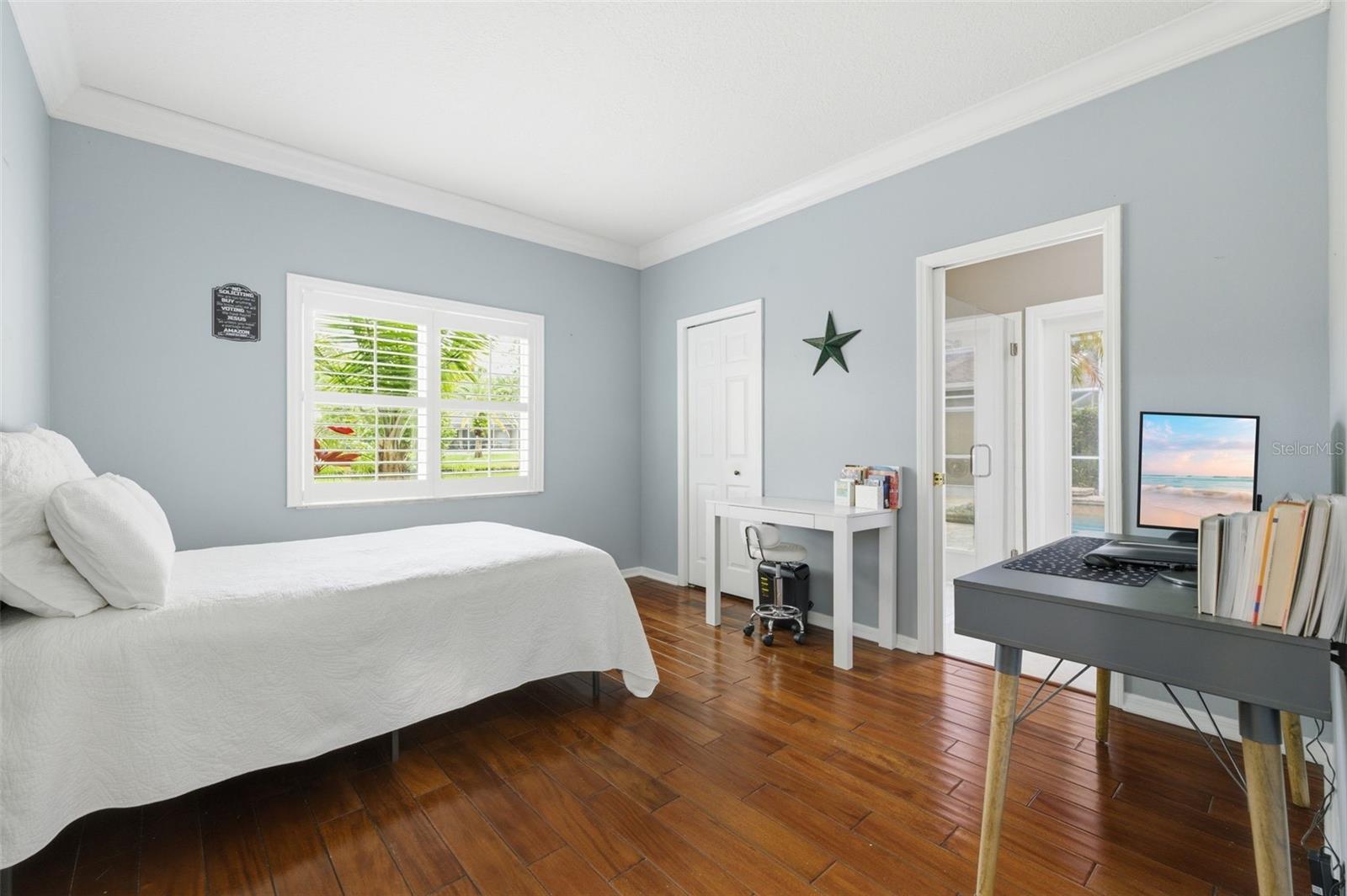 Guest bedroom 3 with private bathroom out to pool area.