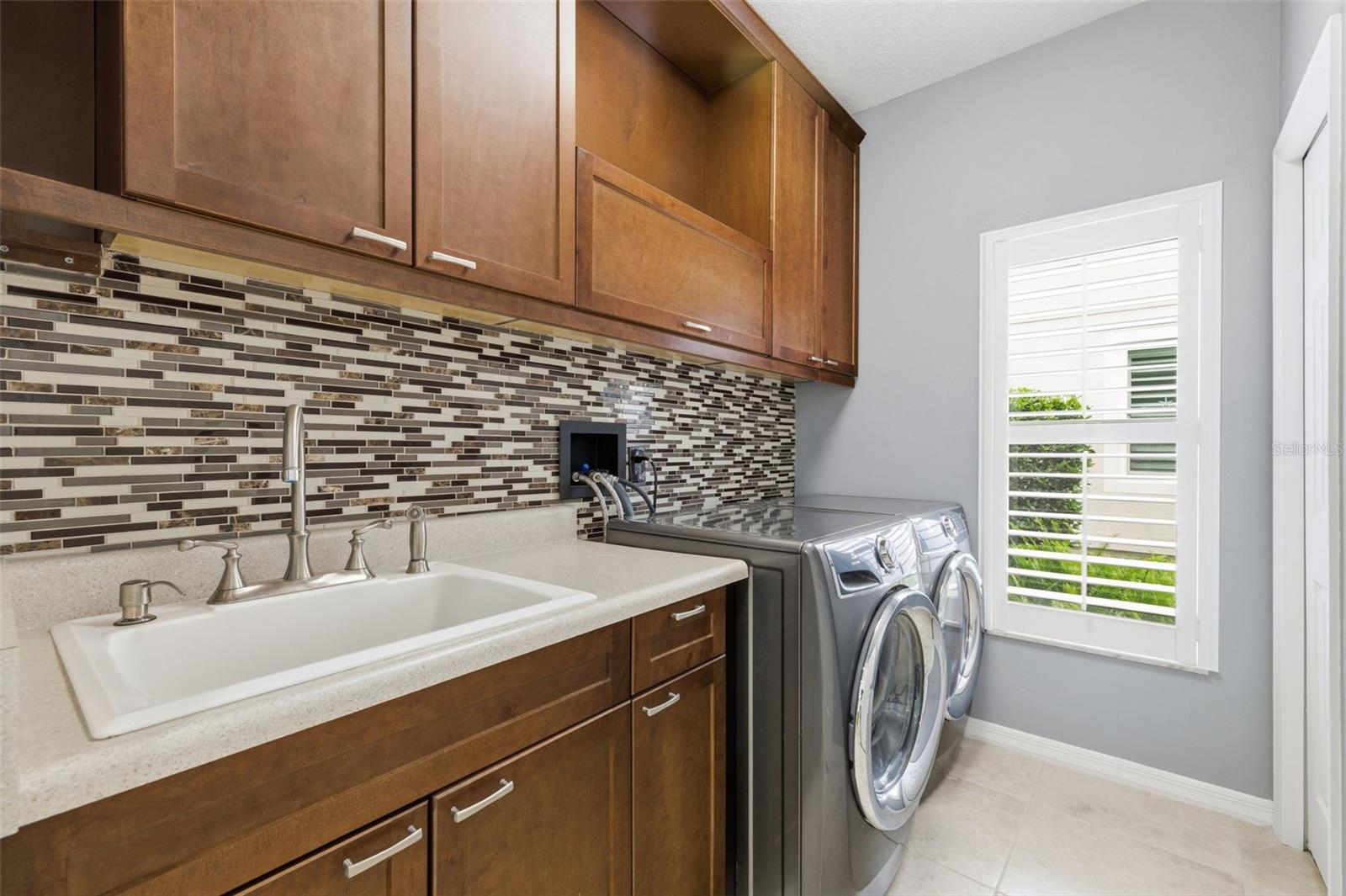 Laundry with custom cabinets.