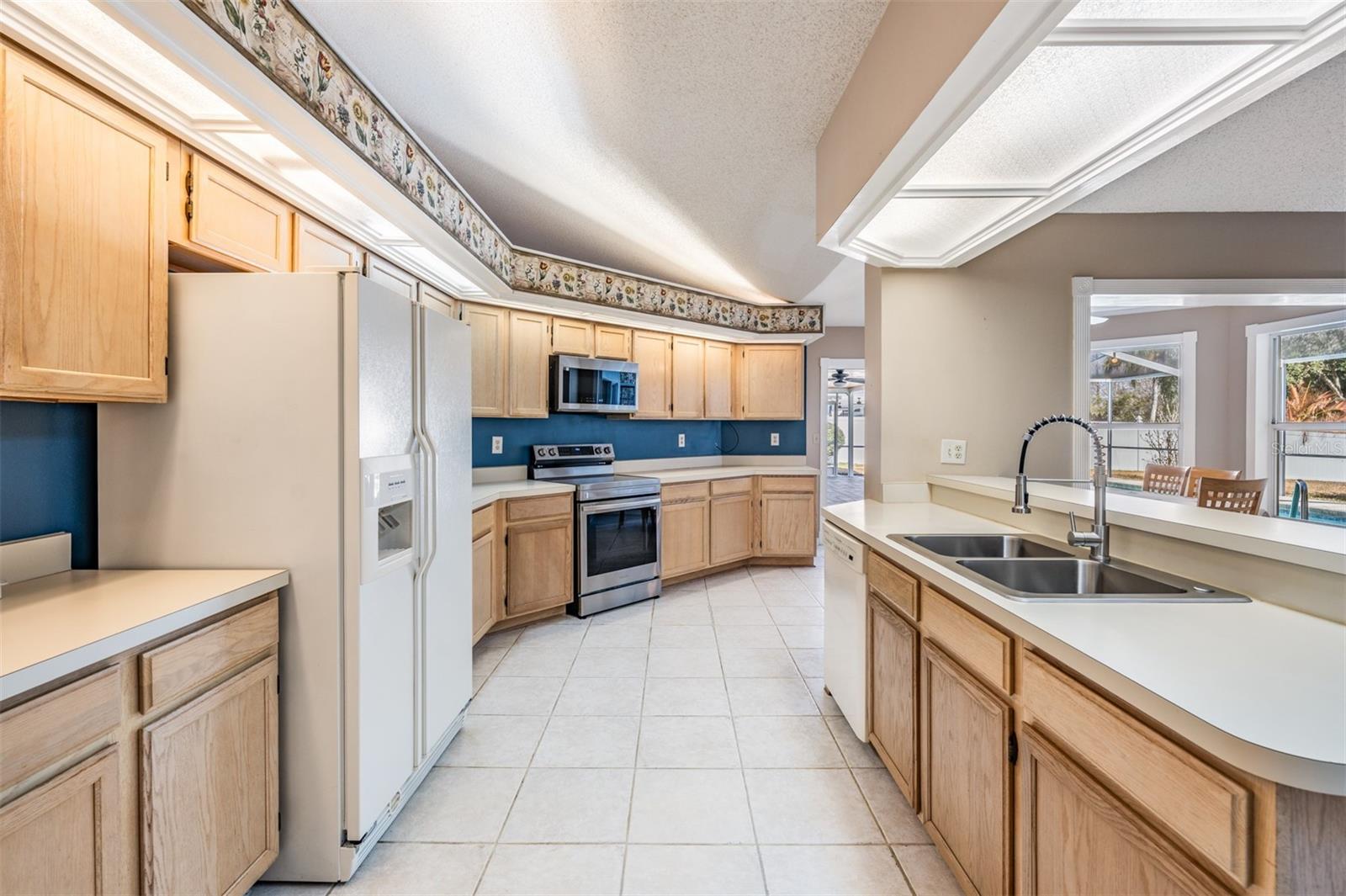 Loads of cabinets and counter space in this functional kitchen