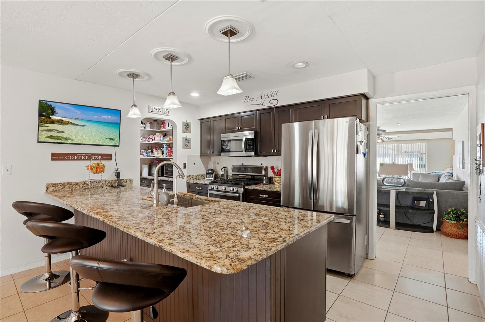 Granite and pantry complete this kitchen