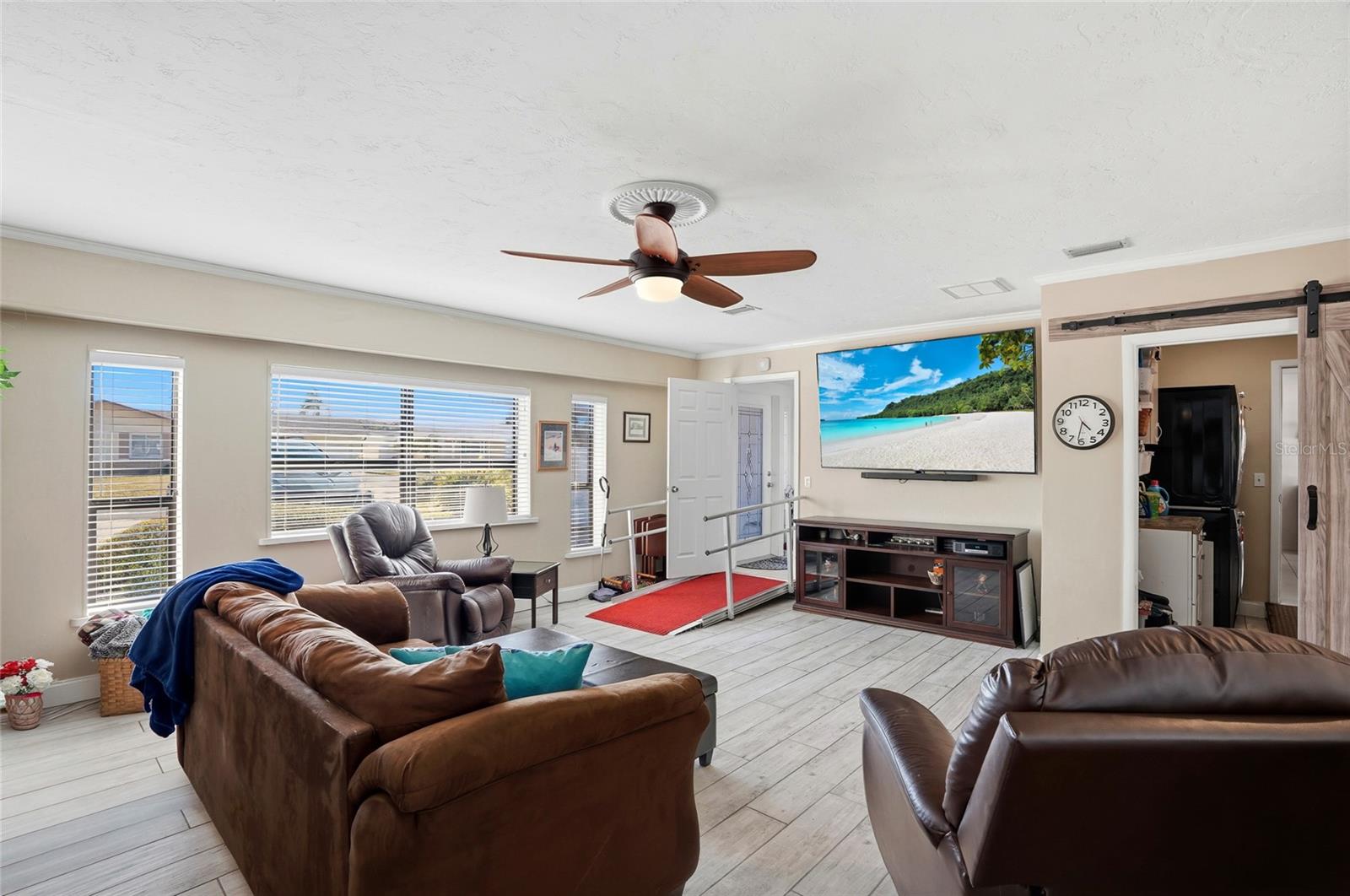 Den provides laundry room/ back yard and kitchen access.