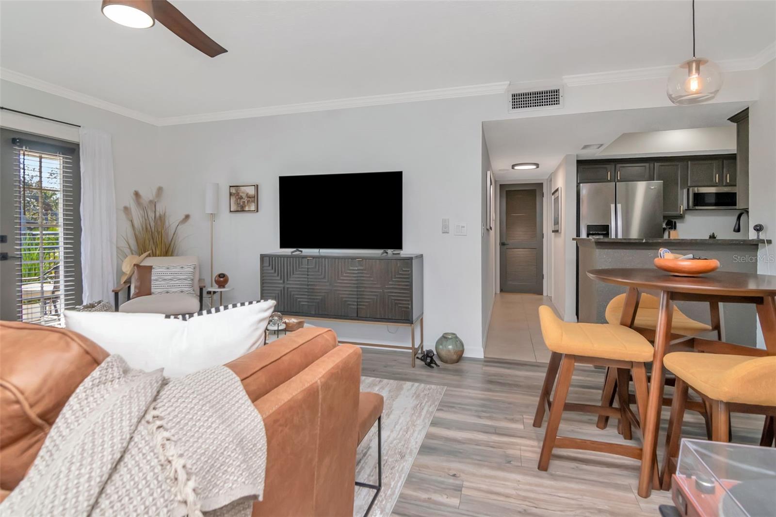 Living and dining room with kitchen in background
