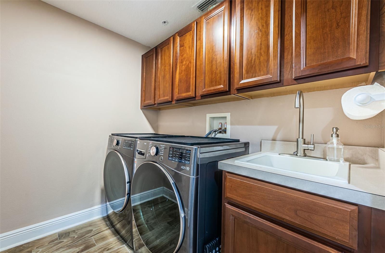 Laundry Room, lots of storage, a sink & counter space