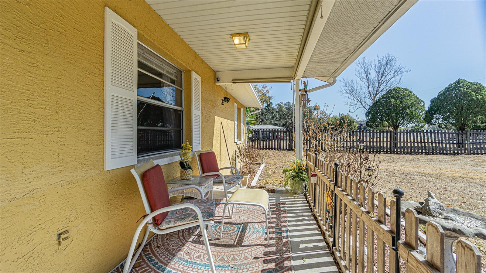 Covered front porch with roll down privacy sunshades