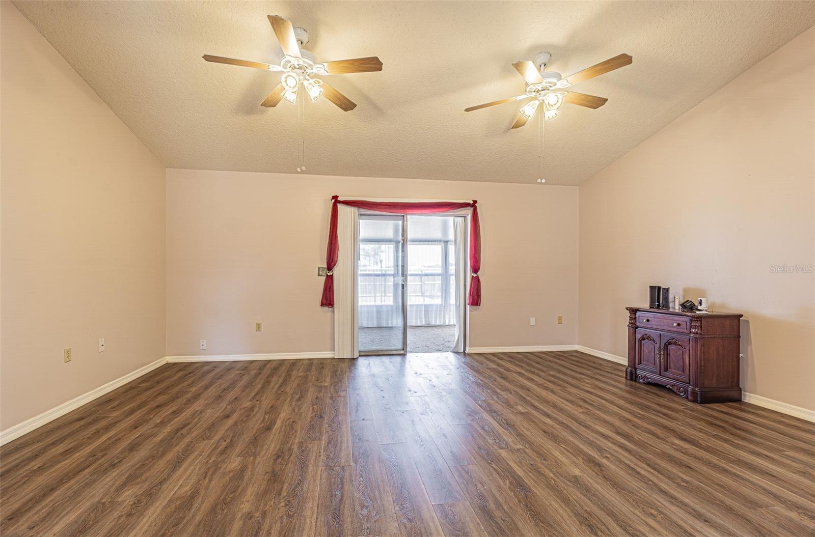 Cathedral ceilings in this spacious Great room with sliders to sunroom