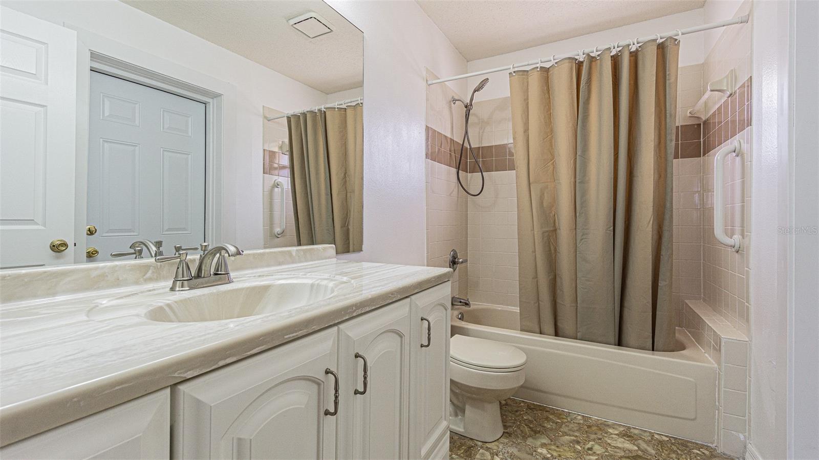 Owners bath ensuite with exit door to access out buildings