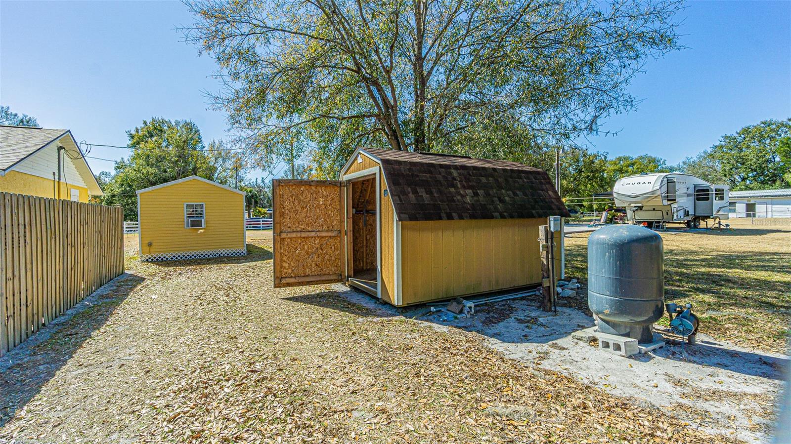 She Shed, Barn shaped lawn shed and well on sideyard outside fence