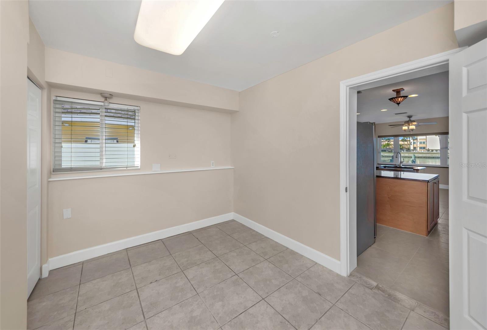 bonus room with a closet just off the kitchen provides flexible space ideal for a home office, guest suite, or hobby room