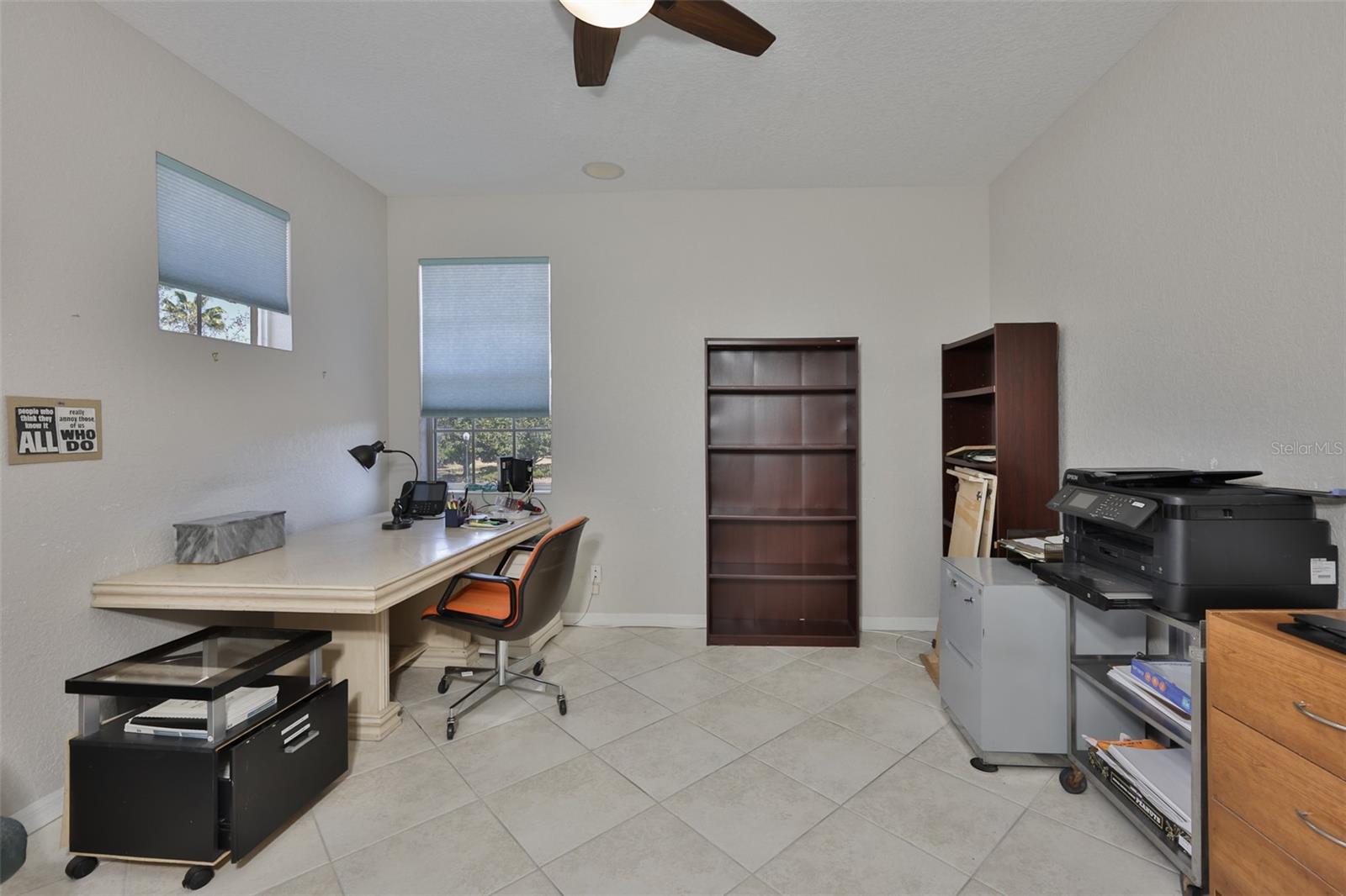 This room has neutral paint tones and has connected speakers for the surround sound speaker system.