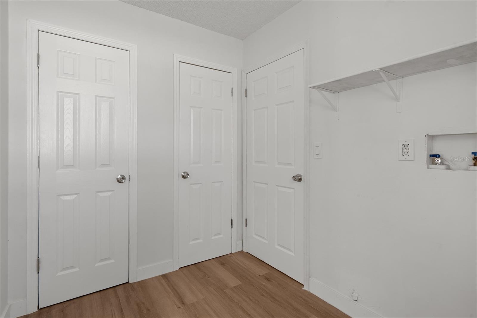 Laundry room with storage closet and pantry
