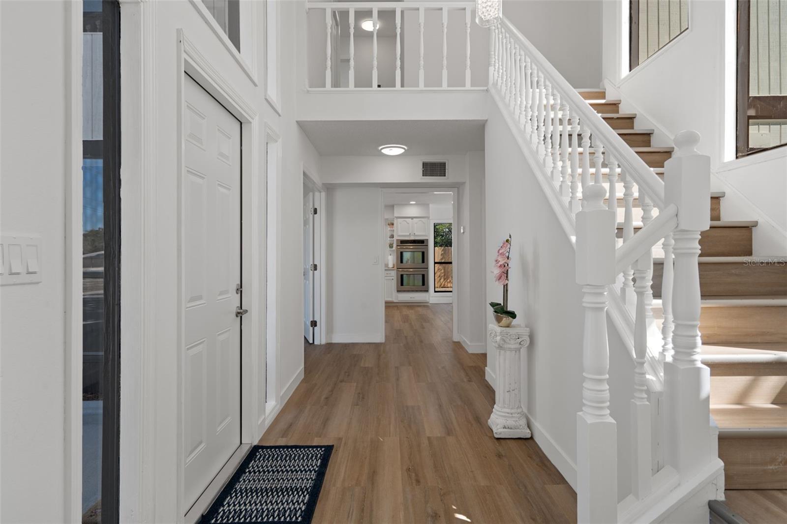 Notice the soaring ceiling in the foyer, and the freshly painted walls throughout the home