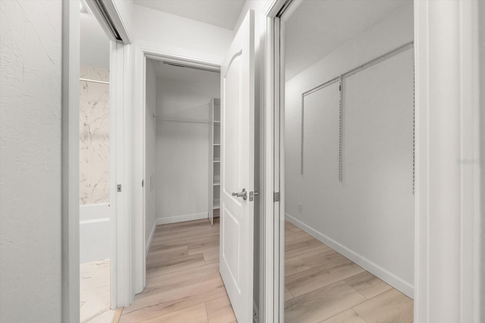 large primary walk in closet with 2 doors for easy access