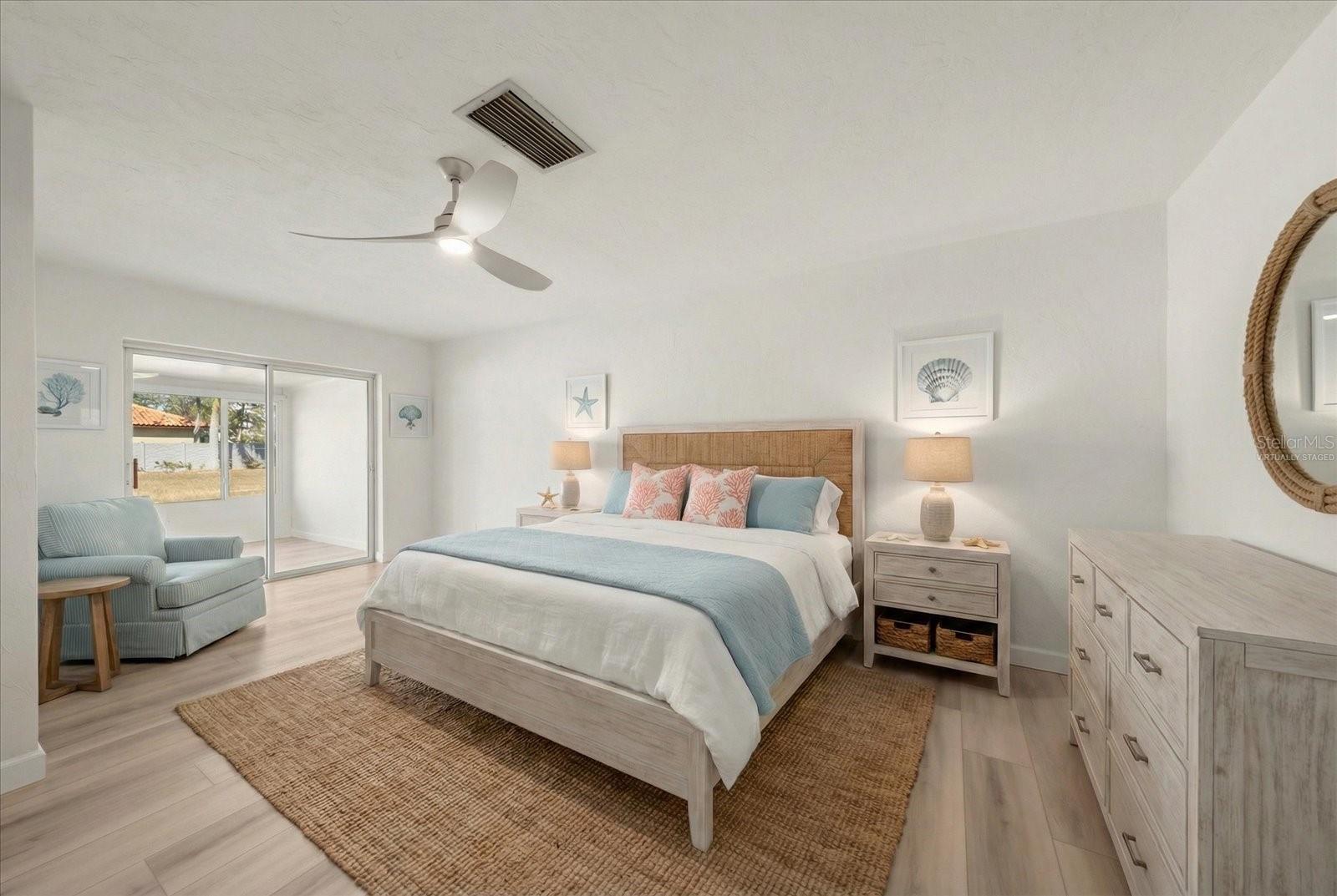 Primary Bedroom - Virtually staged, sliders out to the Florida room keep this room bright and airy