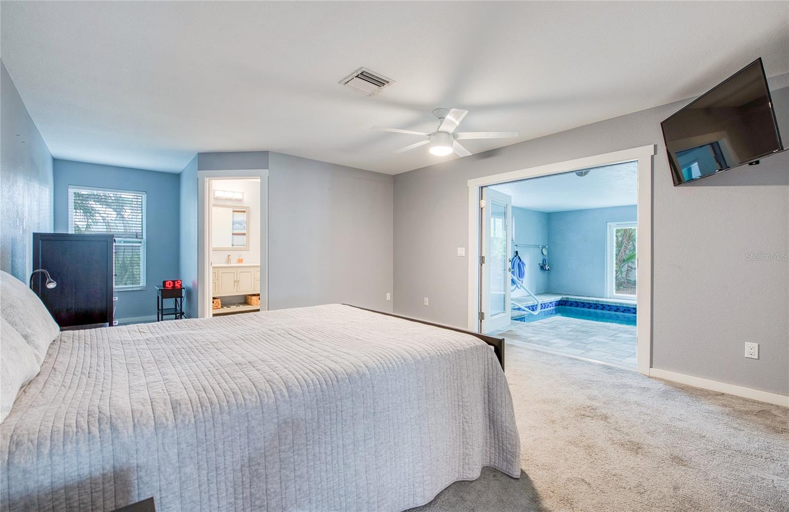 First Floor Primary Bedroom with En Suite and French Doors open to Pool Area