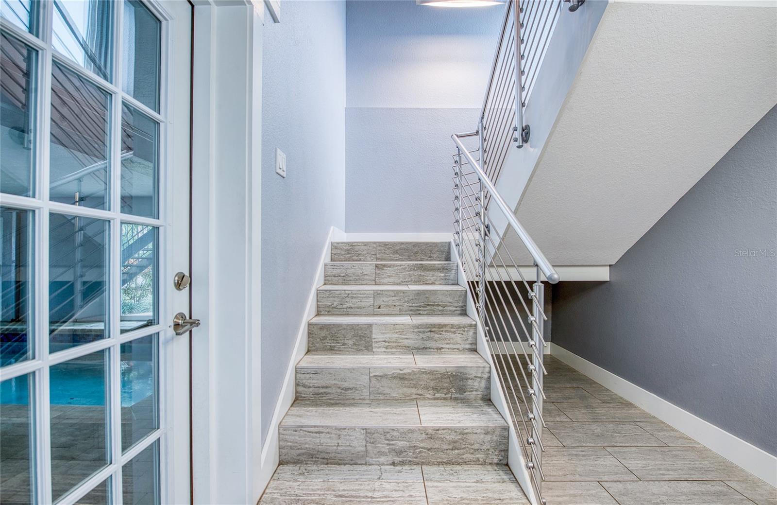 Stairway to Second Floor with Pool Area access and custom railing
