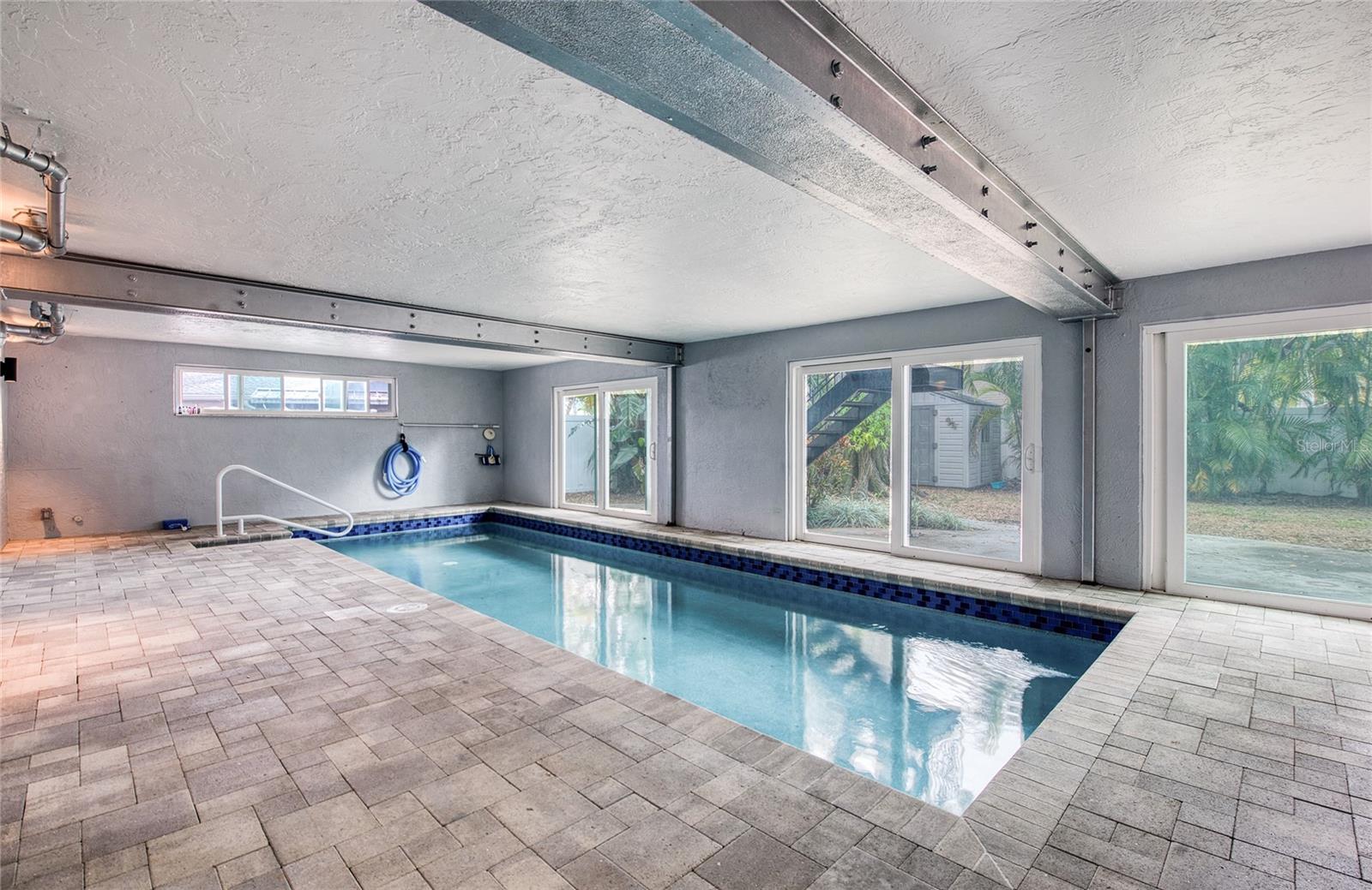 Indoor Pool Area with pavers and rear yard access