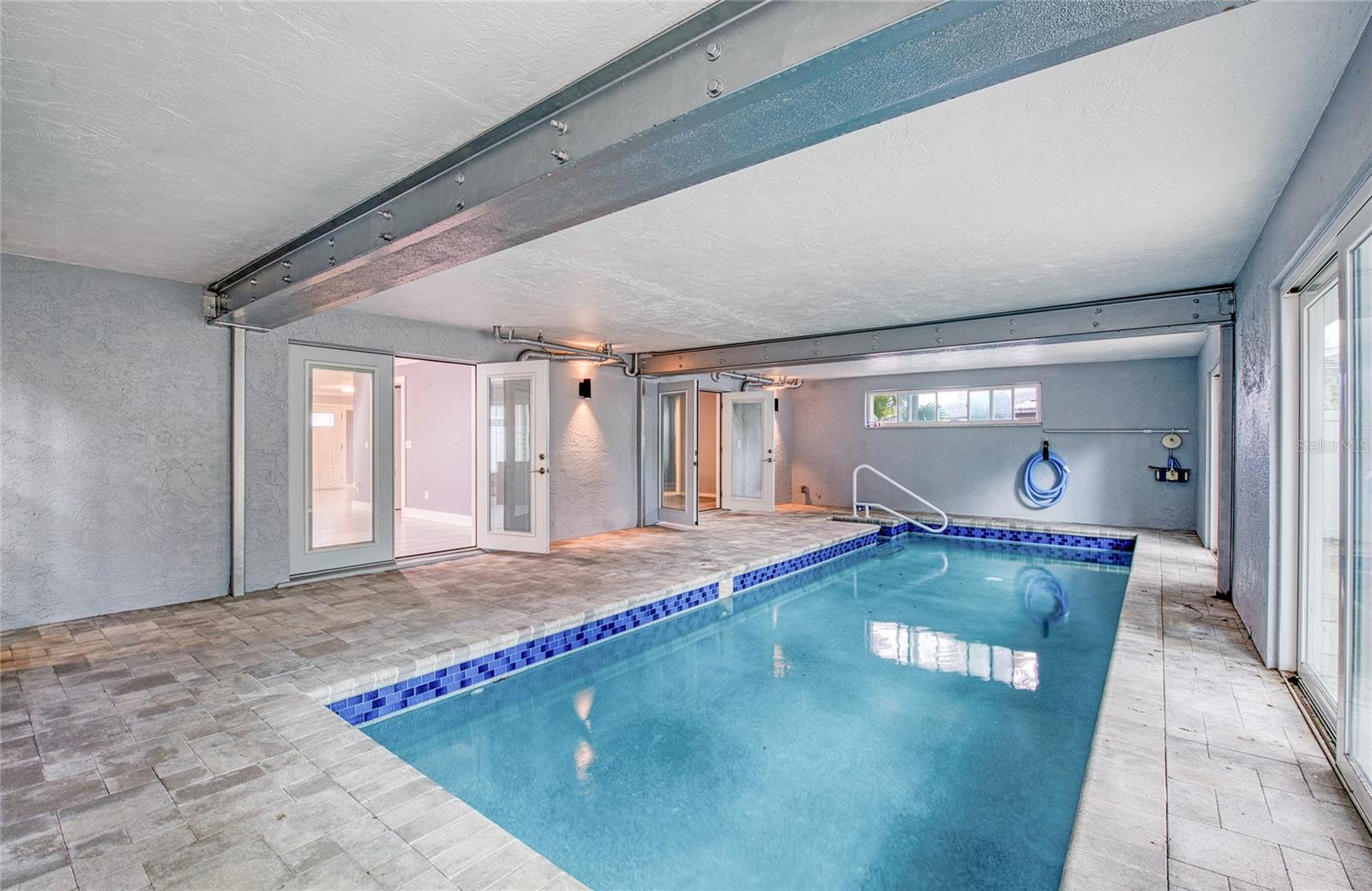 Indoor Pool Area with French Doors to Living Area open
