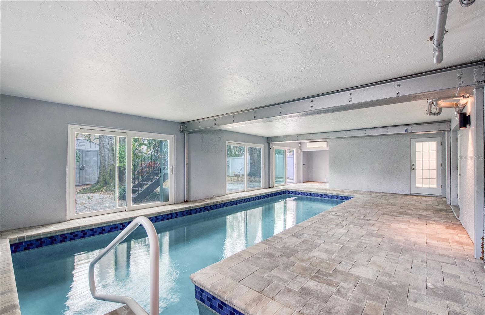 Indoor Pool Area from First Floor Primary Bedroom French Doors