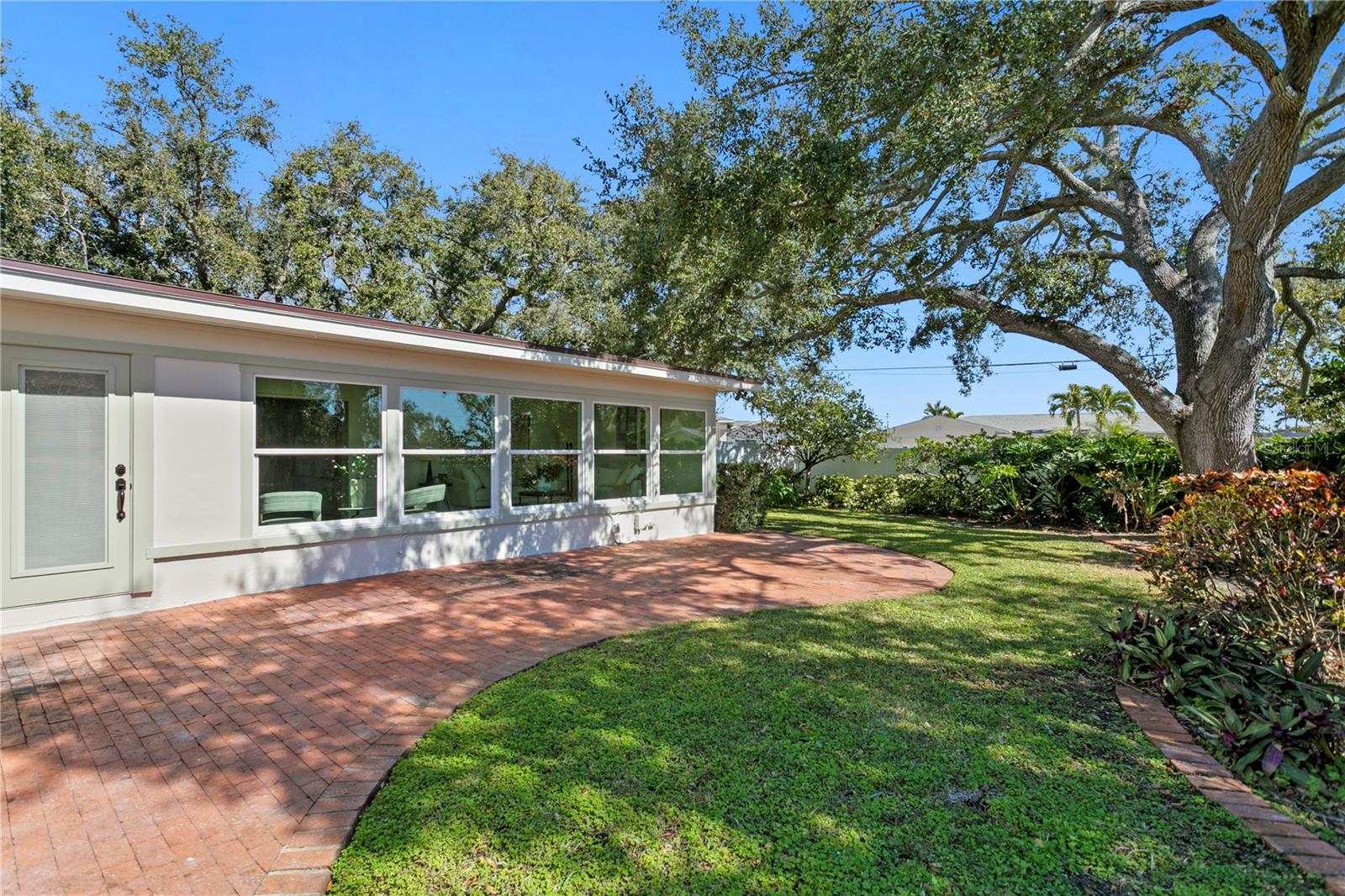 Backyard, pavers and fully landscaped with trees and privacy fencing