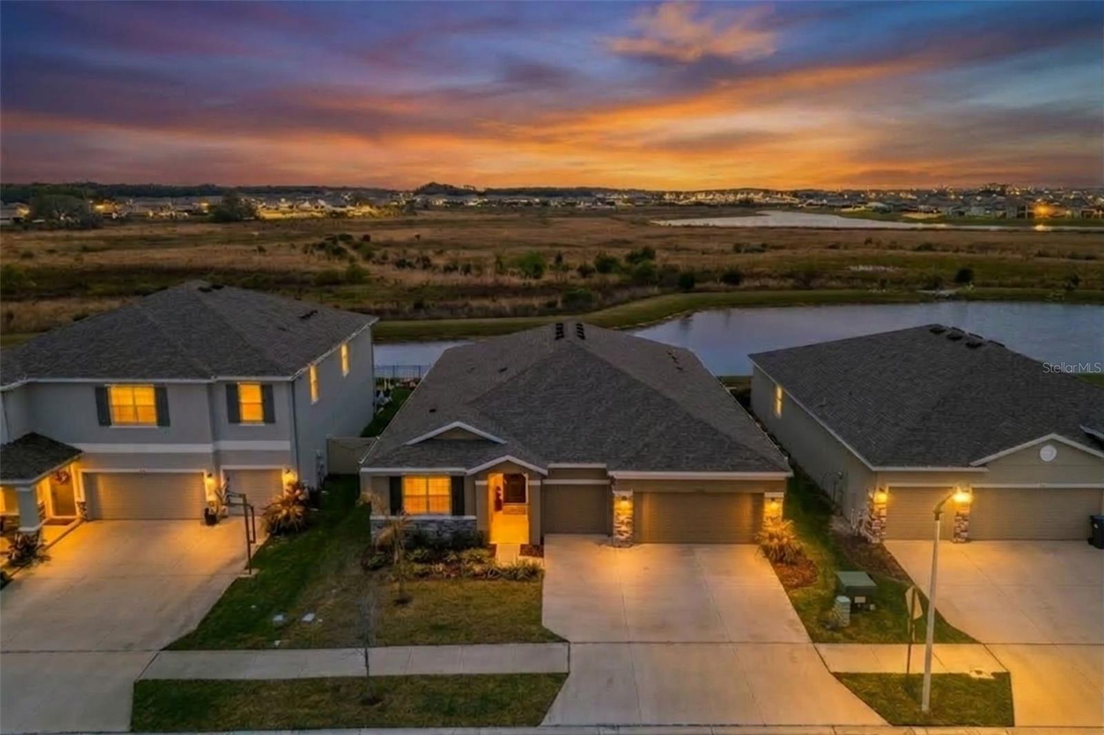 Stunning curb appeal set on a premium pond lot with wide, sparkling water views and beautifully maintained landscaping.