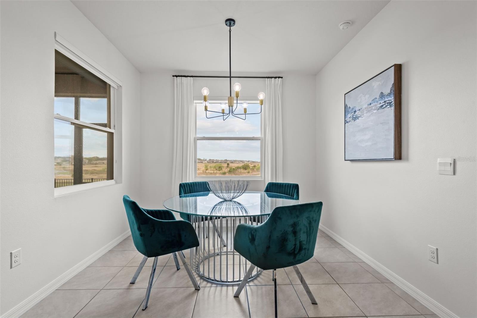 Bright breakfast nook overlooking the backyard and water, creating a peaceful spot to start the day.