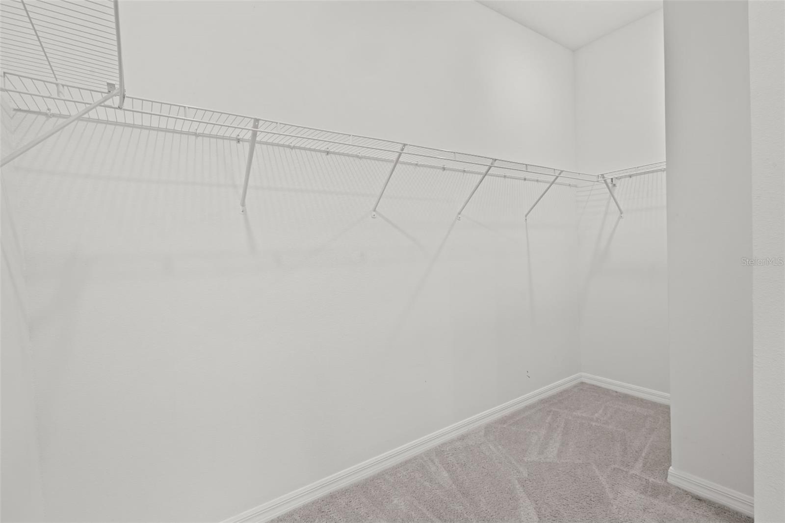 Generous walk-in closet offering plenty of space for organization and storage.