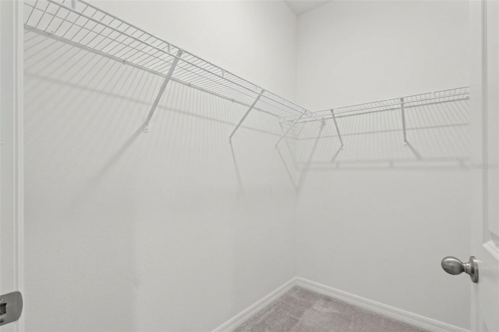 Large walk-in closet providing ample storage within the private suite.