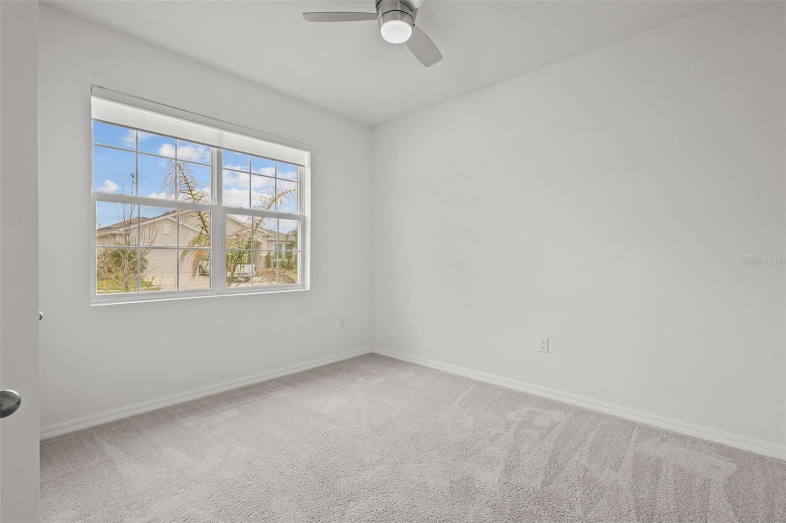 Bright secondary bedroom connected by a convenient Jack and Jill bathroom.