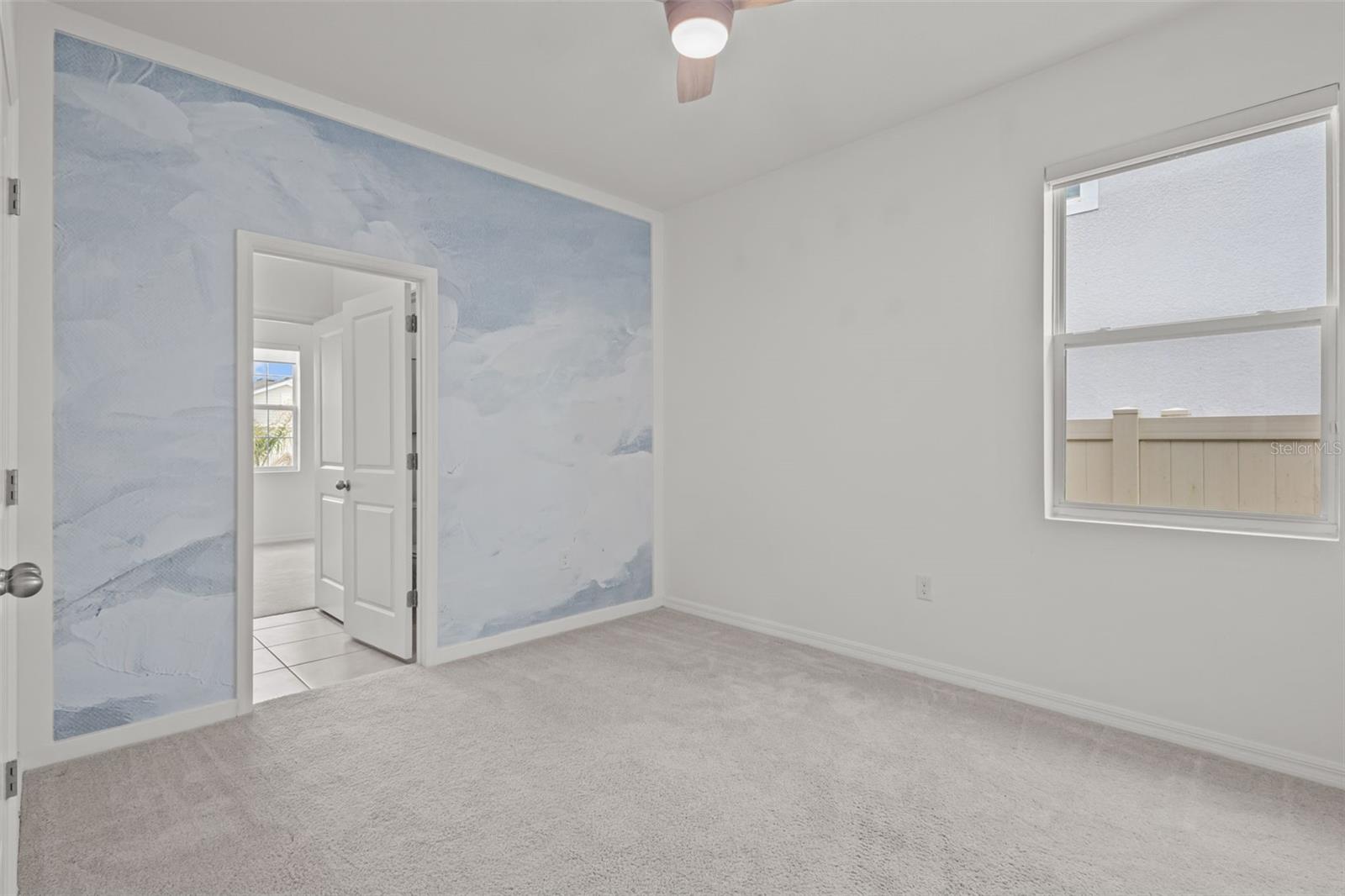 Additional spacious bedroom with direct access to the shared Jack and Jill bathroom.