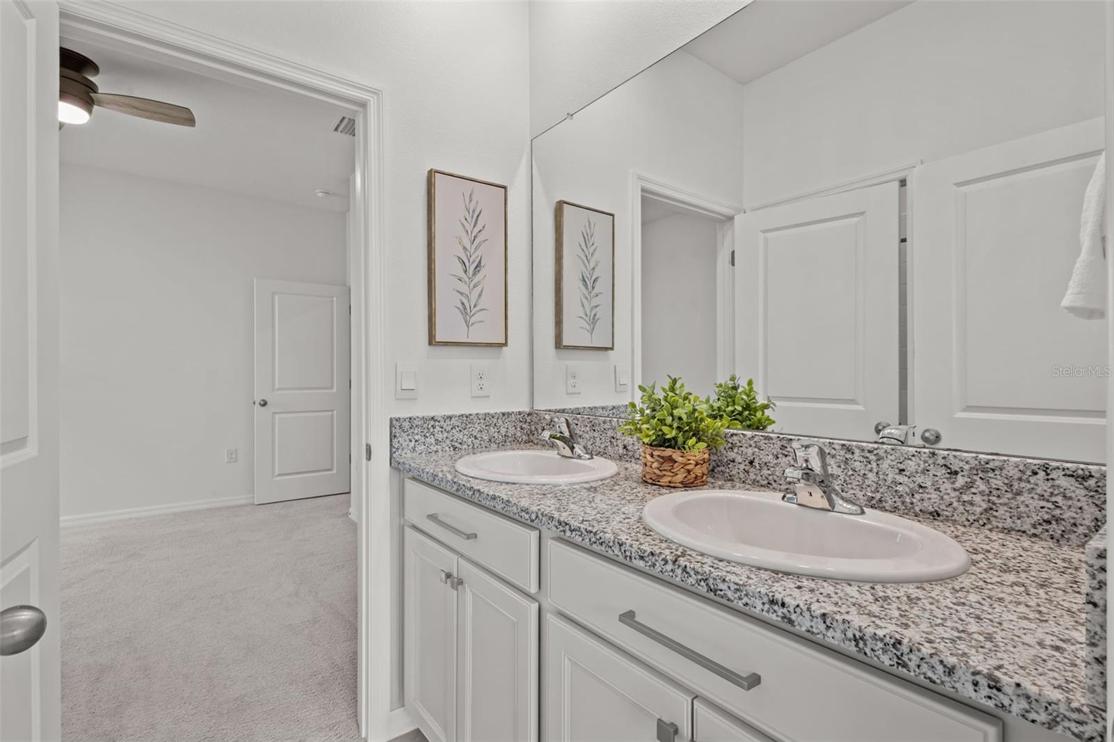 Well-appointed Jack and Jill bathroom with dual access serving the secondary bedrooms.