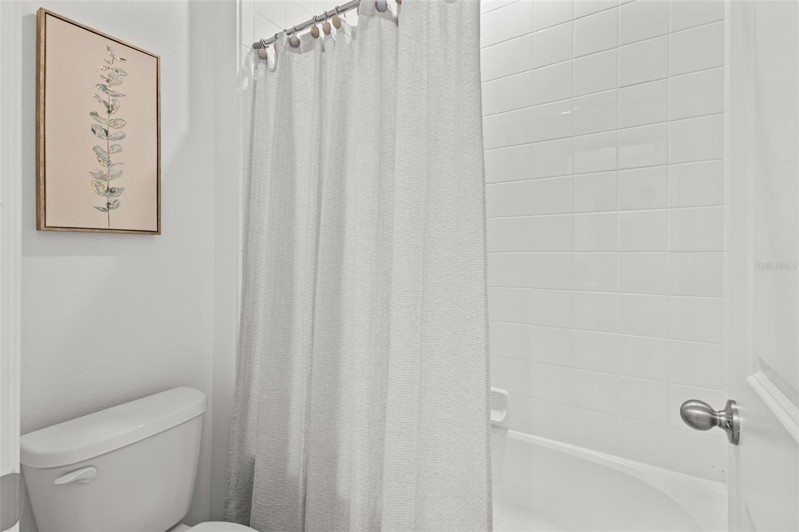 Well-appointed Jack and Jill bathroom with dual access serving the secondary bedrooms.