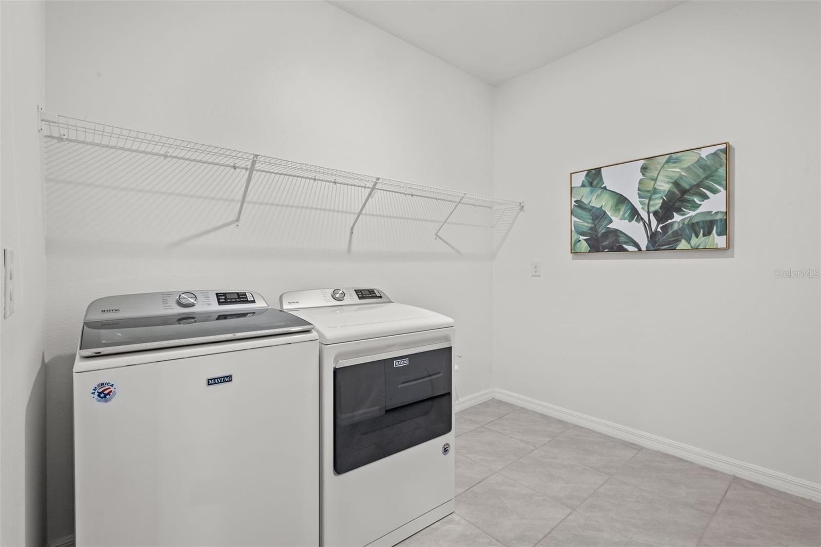 Functional laundry room with ample workspace and storage.