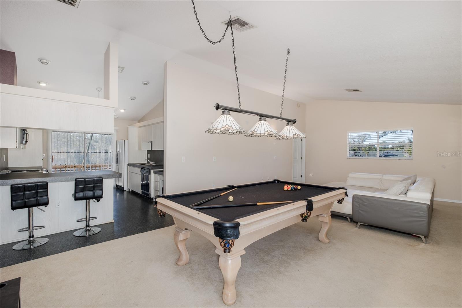 Second level, Family room / loft with full-kitchen and balcony.