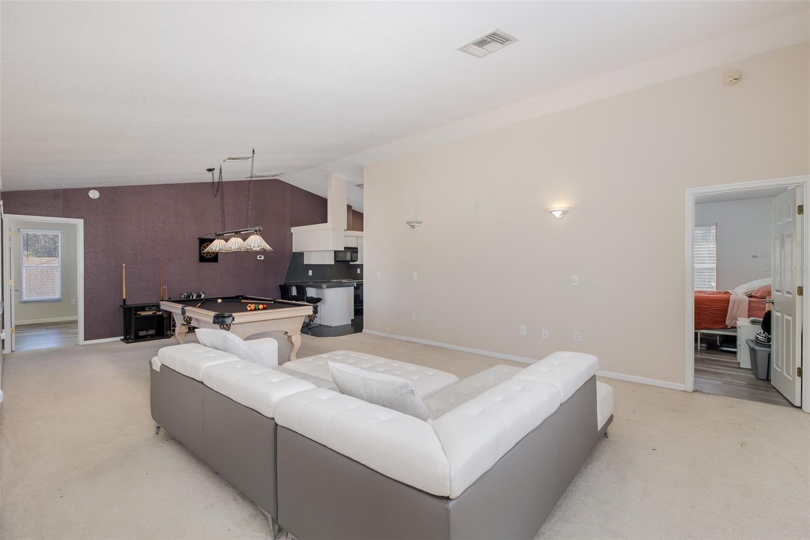 Second level, Family room / loft with full-kitchen and balcony.