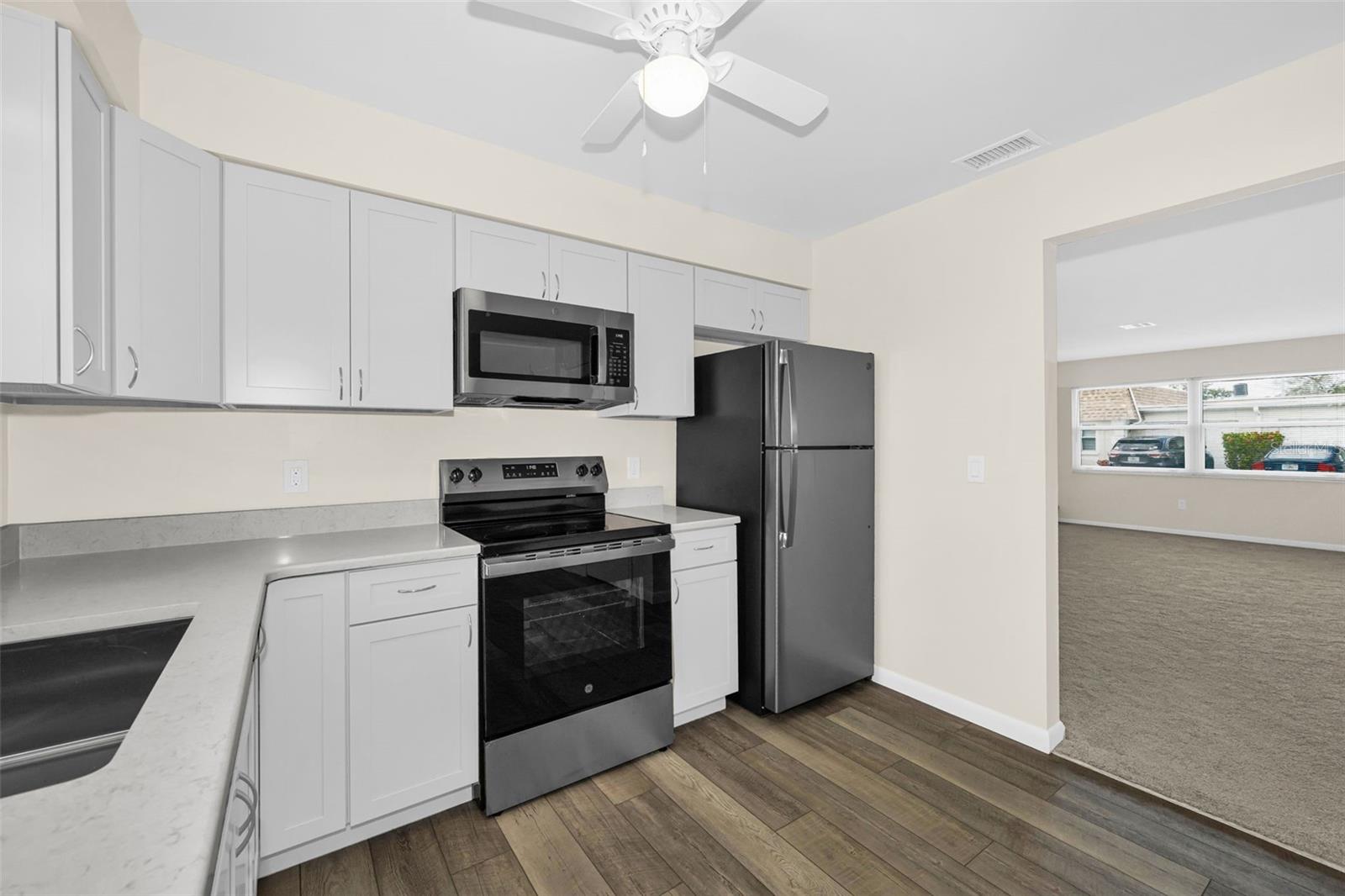 SPARKLING NEW KITCHEN, NEVER USED! Located at the back of the home.