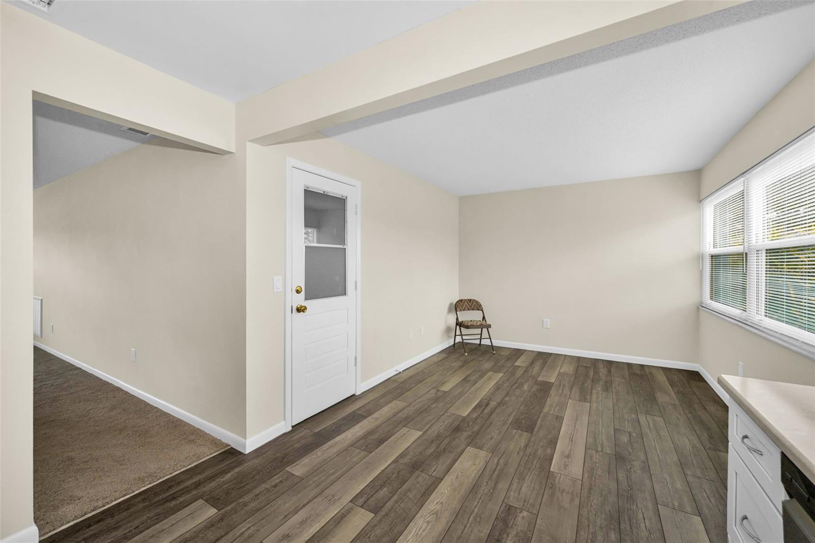 Looking from the kitchen sink to the door into your private garage.  This area can be for another sitting room or dining area or home office!