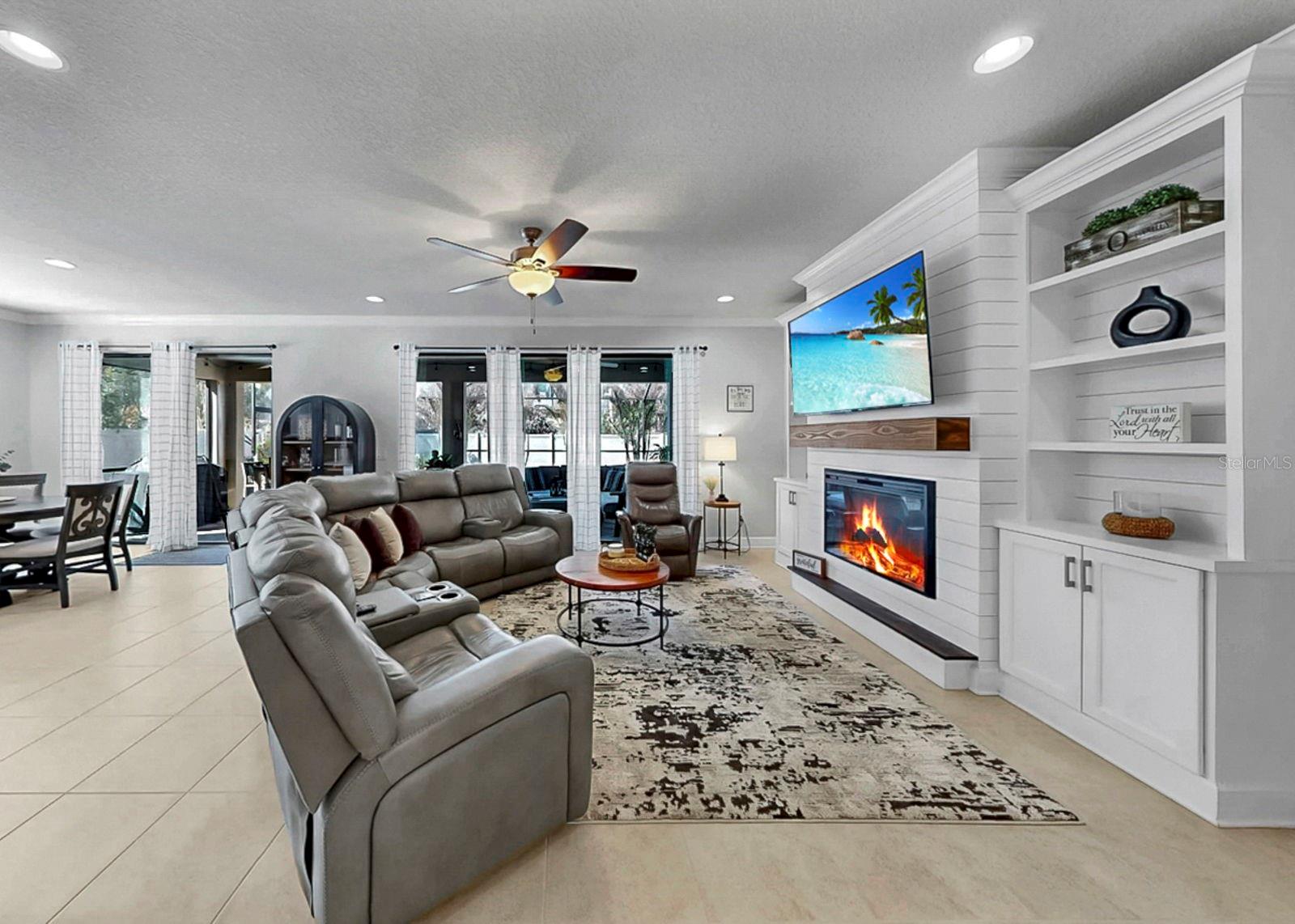 Electric fireplace with wood mantle and hearth, plus a wall mount for a TV