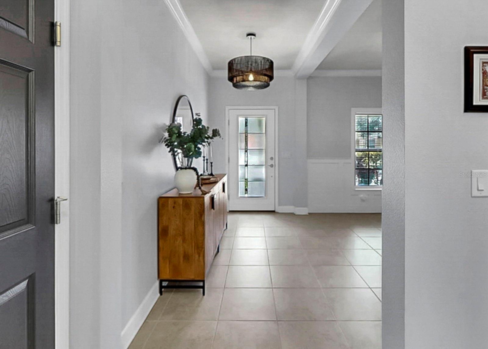 Foyer with glass entry door and updated lighting