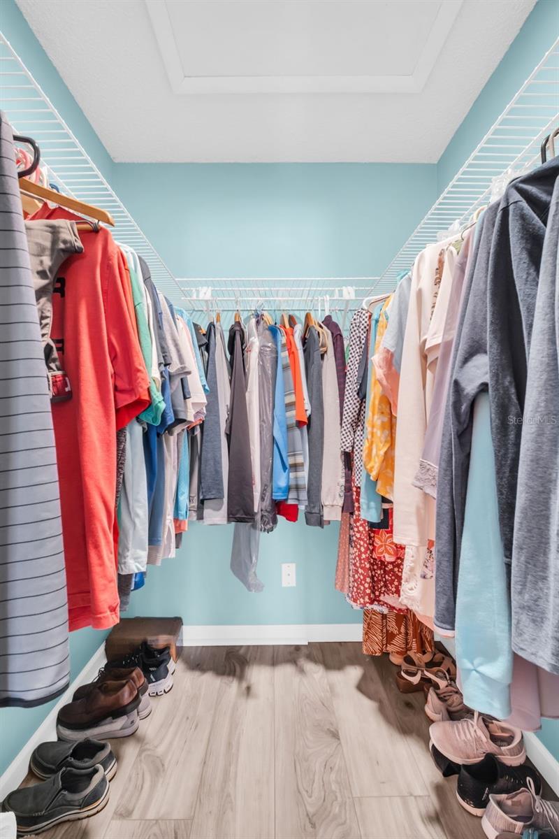 Gracious primary walk-in closet big enough for all your things~