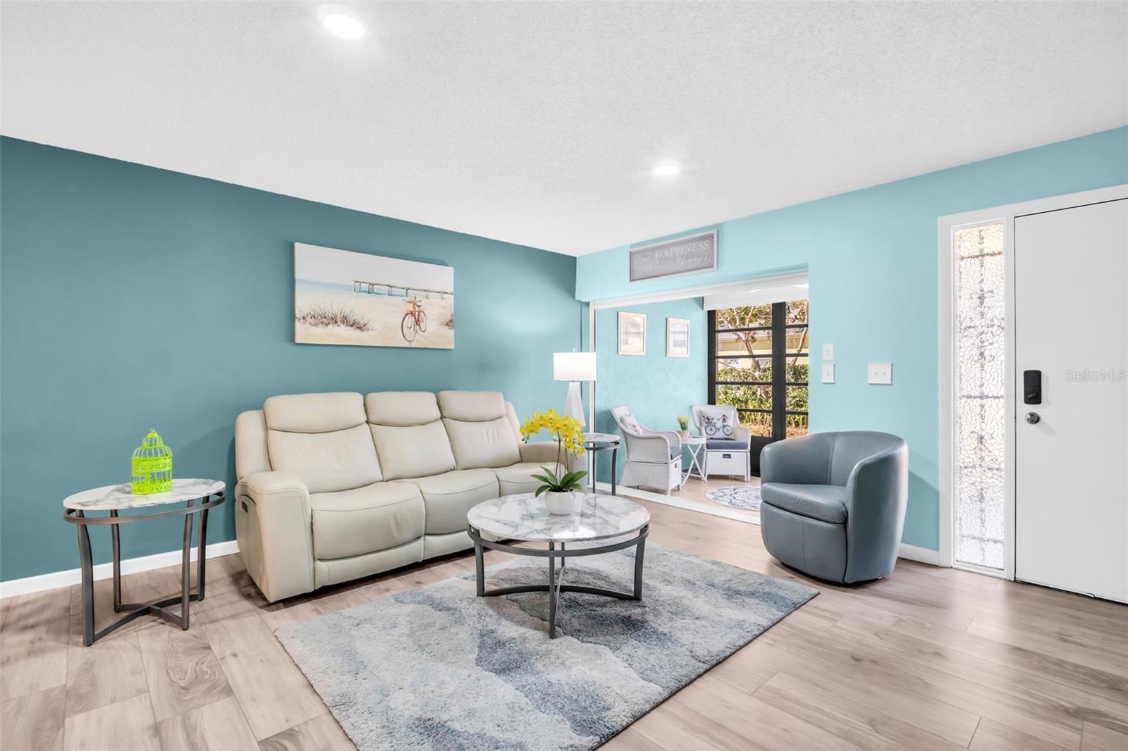 Main living is open to the sunny Florida room with private green views~