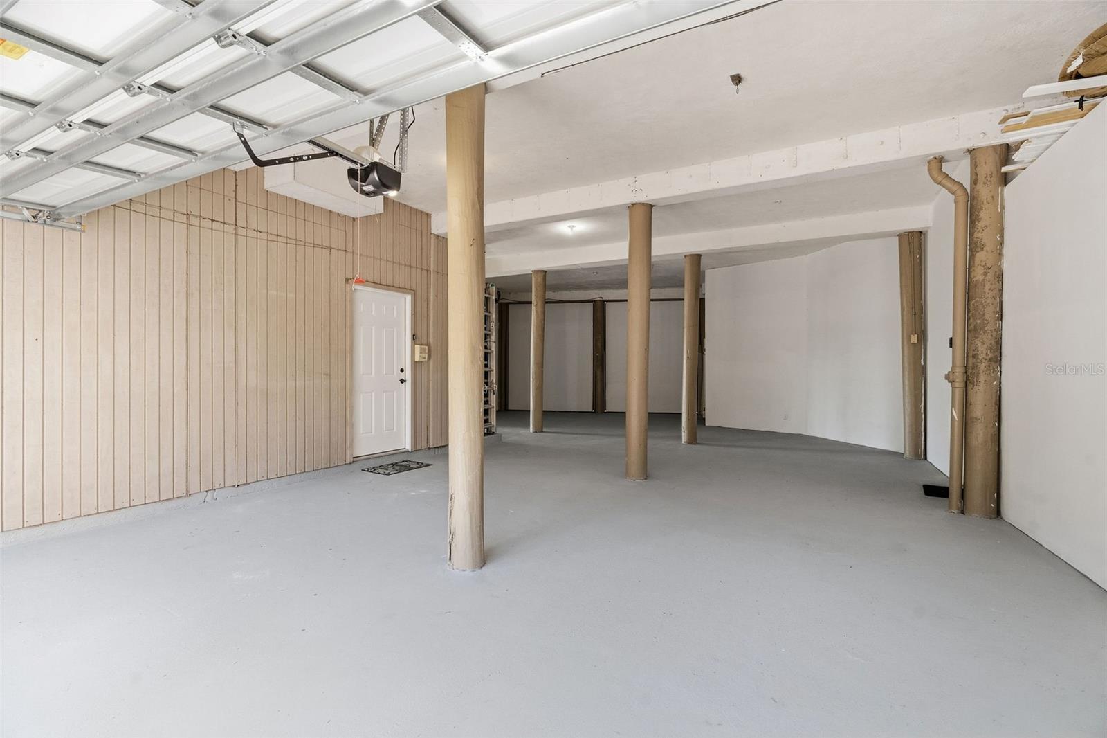 2 car+ Garage. Elevator hall door on left and interior stair door on the right