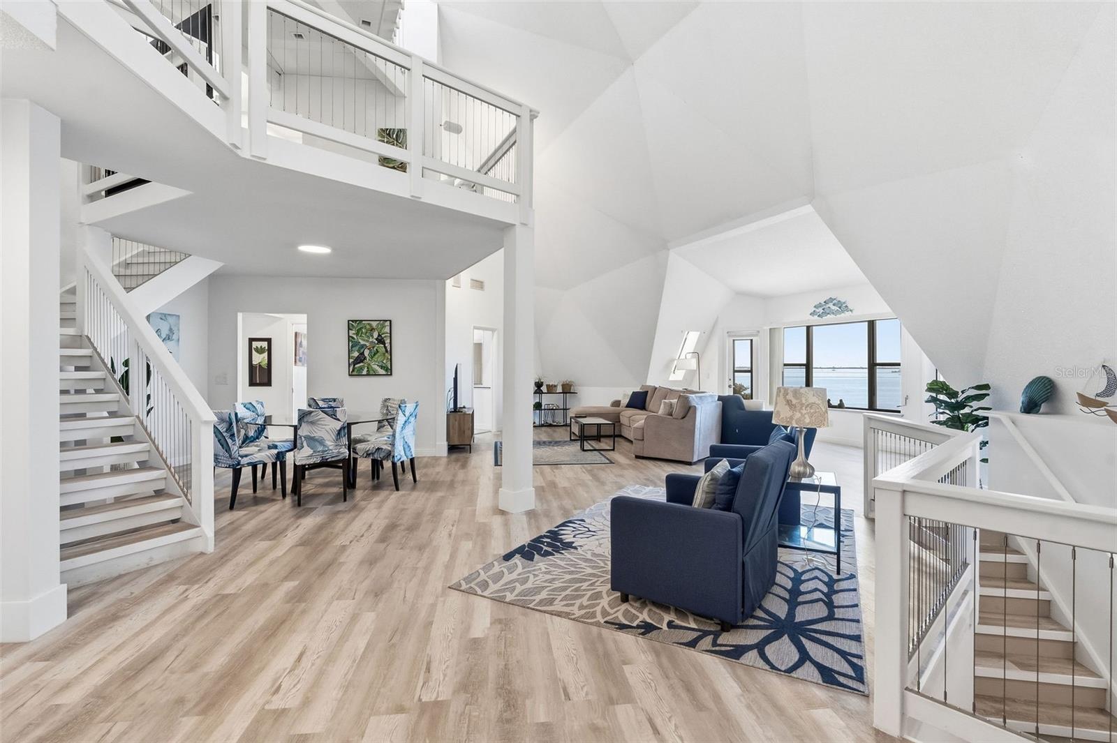 Dining room, Livingroom and entry stairs from ground level, below. Primary suite entry stairs on left