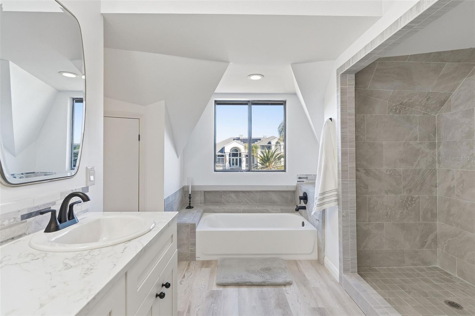 primary bathroom with tub and shower