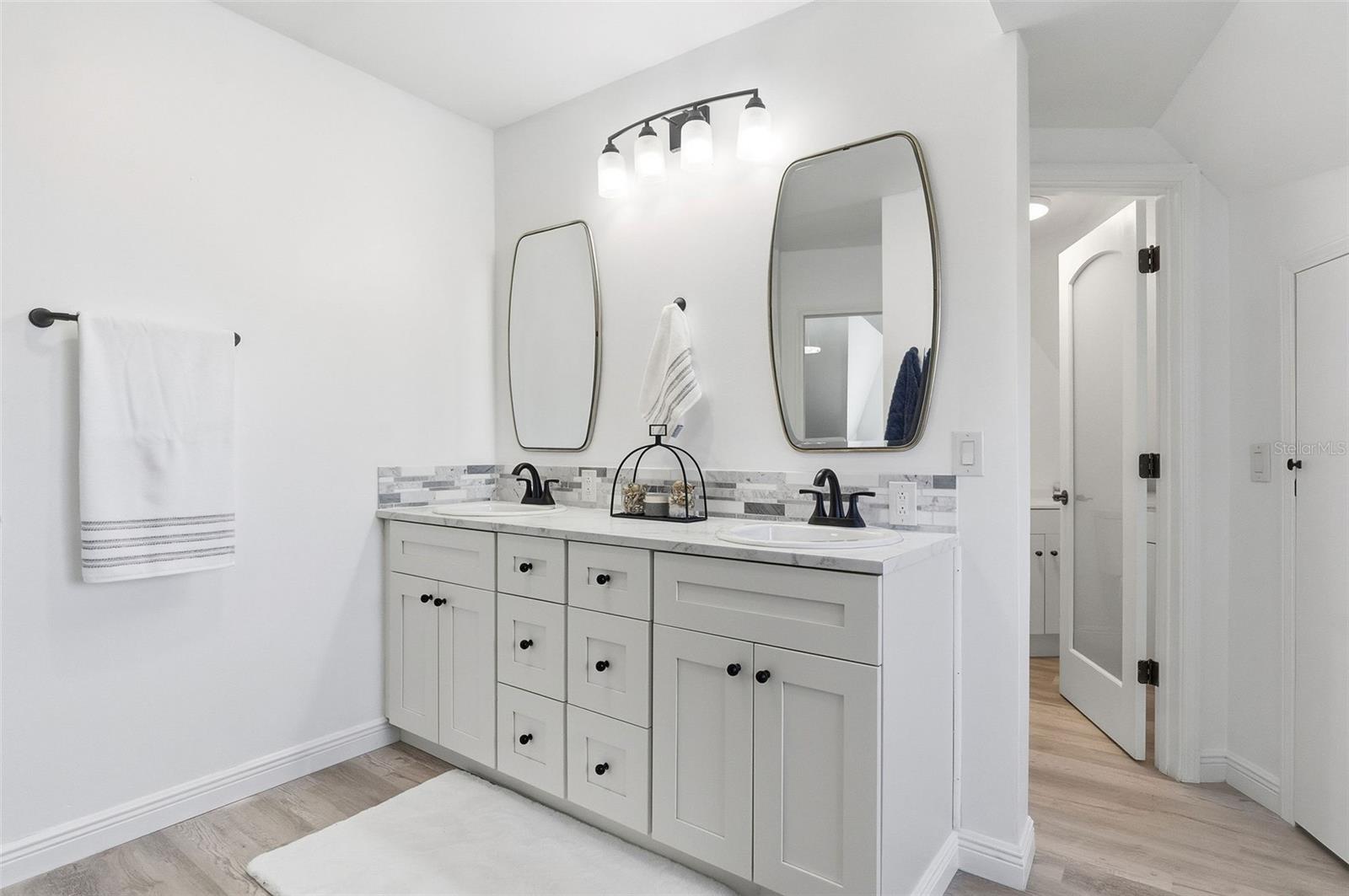 Primary Bathroom with powder room to the right