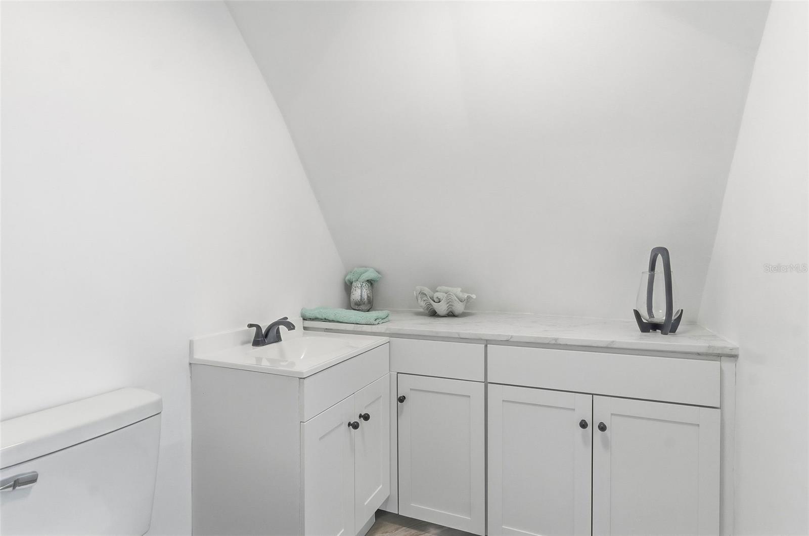 Separate Powder room off Primary Bathroom and entertainment area