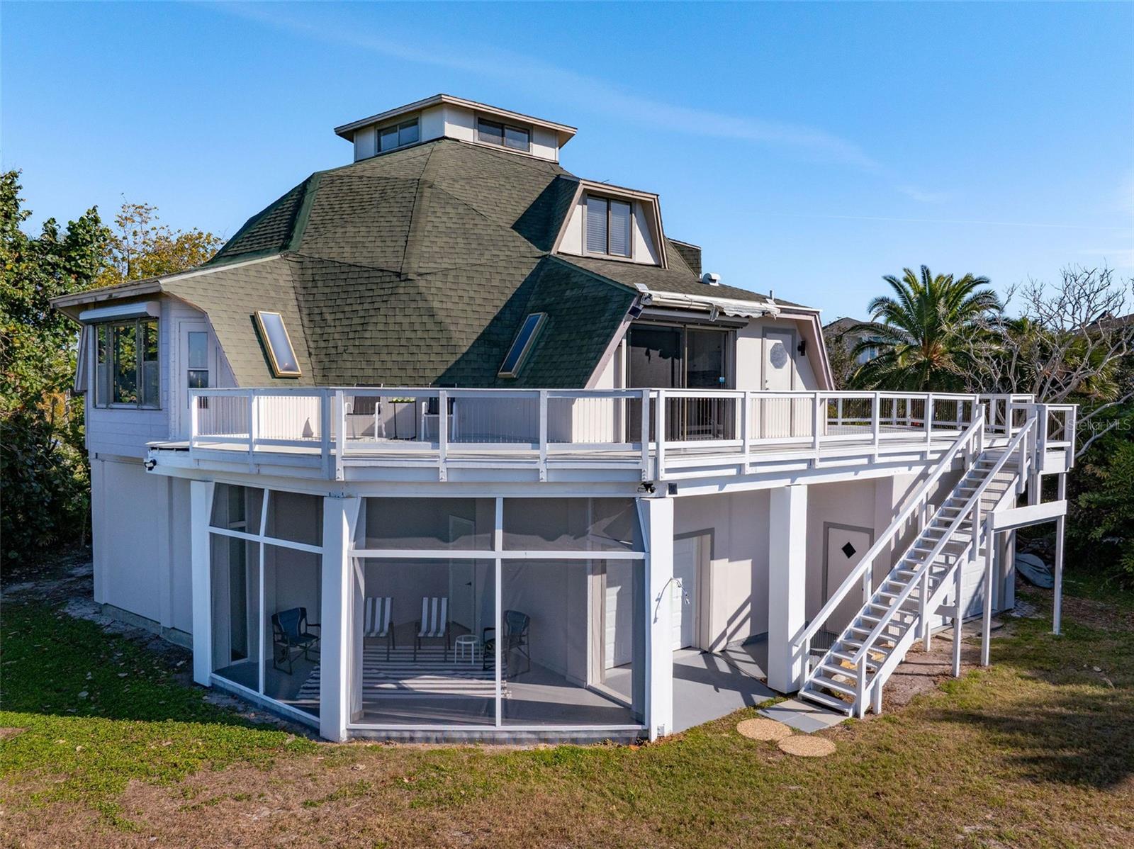 Rear of Home with screened in ground floor patio