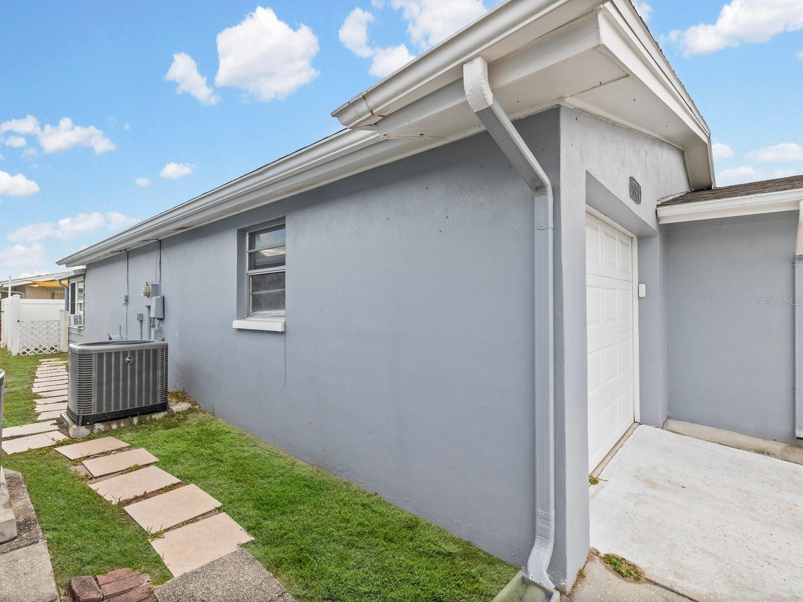 Left side of home lawn staged to enhance