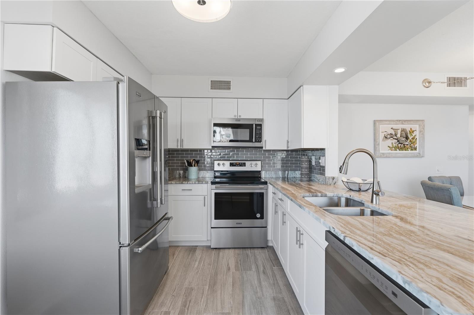 Move in ready. Enjoy a stocked kitchen featuring shaker cabinets and stainless appliances.