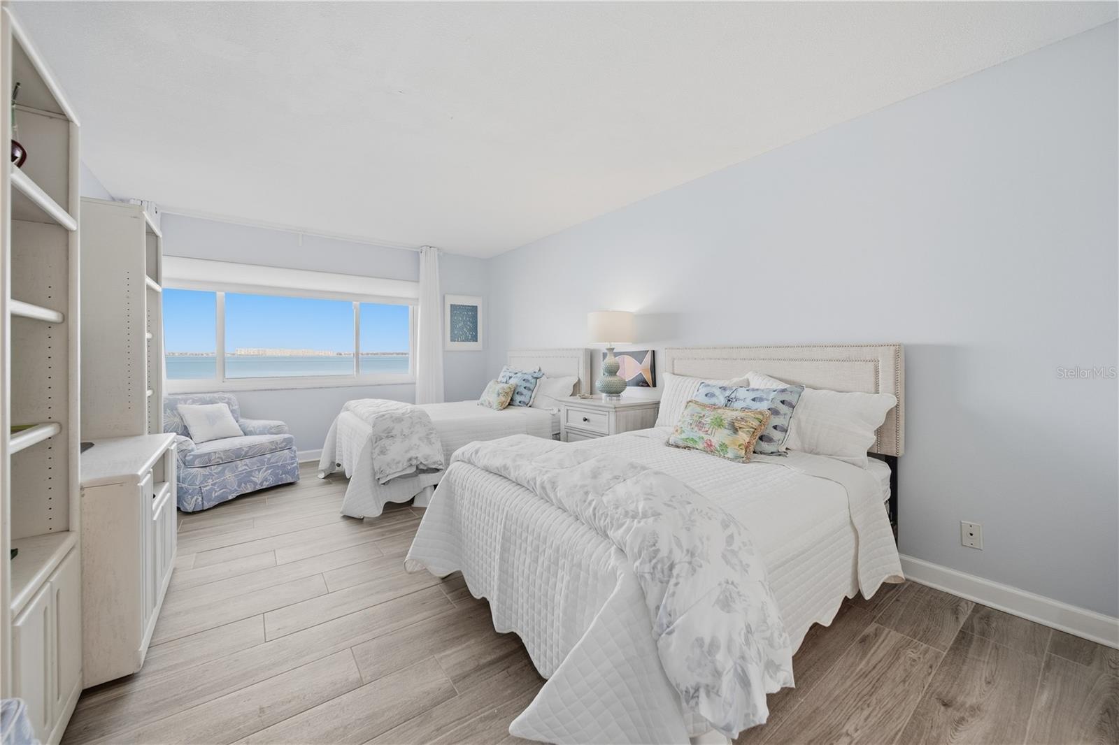Wake up to serene, sweeping views of Boca Ciega Bay from the spacious Primary Bedroom.