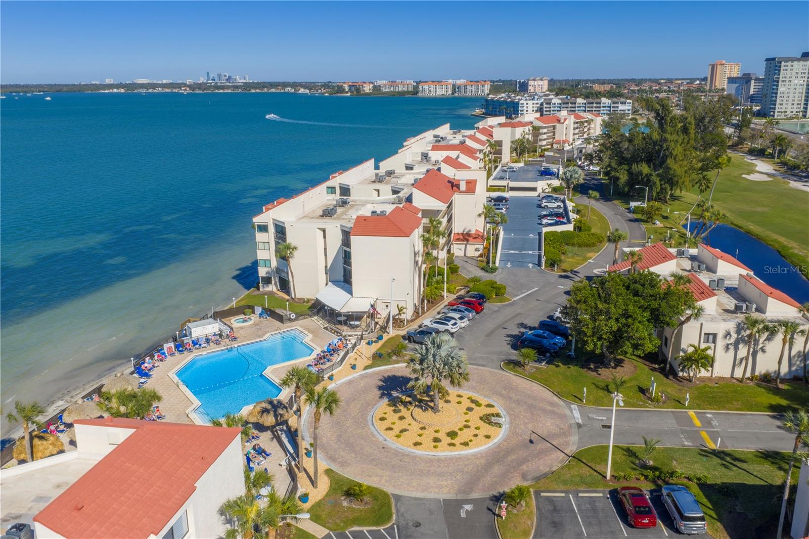 La Puerta welcomes you with lush landscaping, a sparkling pool, and sweeping open water views.